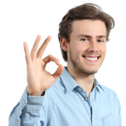 humble dental crowns photo of young man giving thumbs up with white teeth